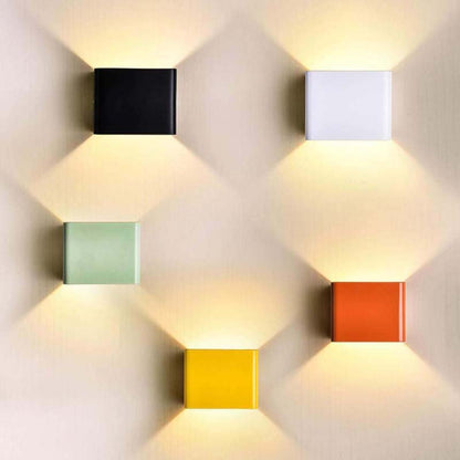 Colorful square wall lights on a textured wall