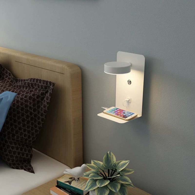 Wall-mounted night light with a smartphone charging station in a bedroom setting.
