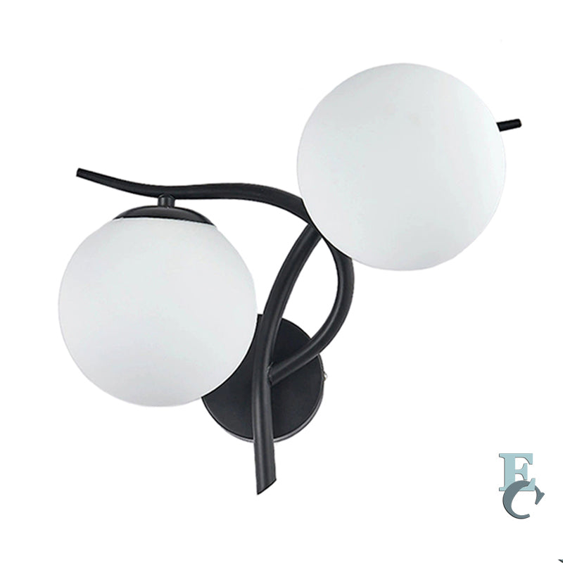 Wall-mounted light fixture with two spherical glass shades on a white background