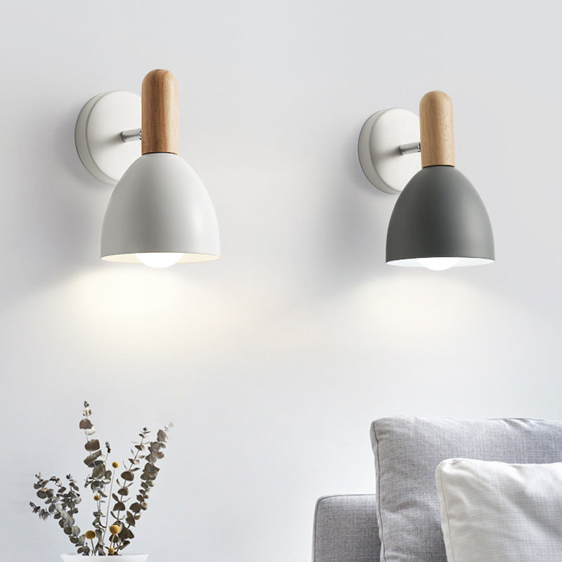 Two wall-mounted lamps with wooden accents on a light gray wall.