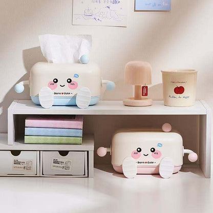 Cute cartoon-themed storage boxes on a shelf with books and a lamp.