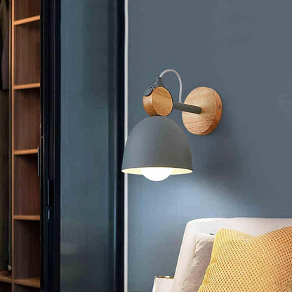 Wall-mounted lamp with wooden accents on a blue wall next to a bookshelf and sofa.