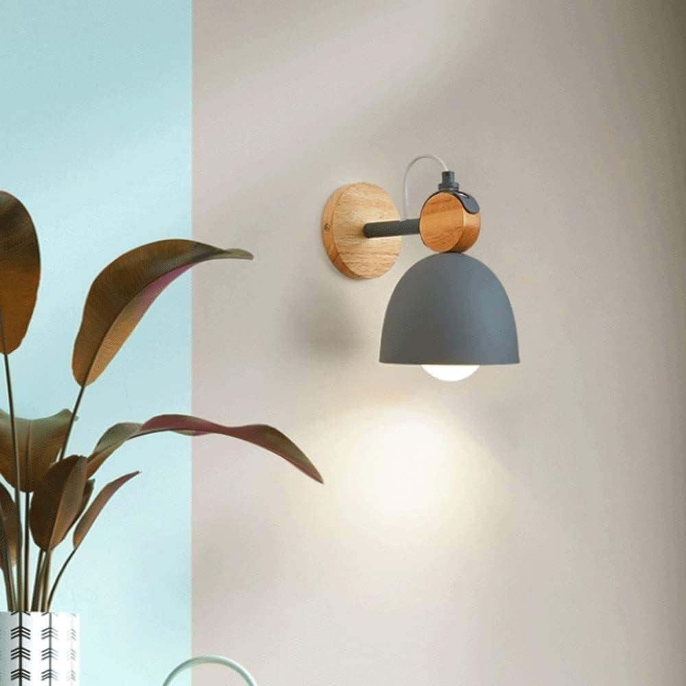 Wall-mounted lamp with wooden fixture and gray shade on a light background
