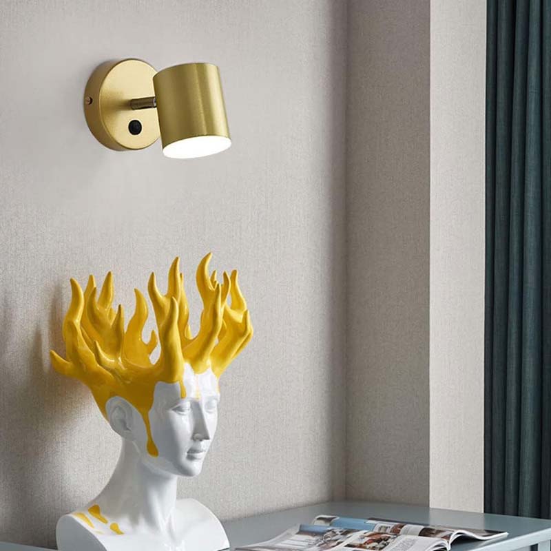 Decorative wall lamp with gold fixture on a neutral wall.