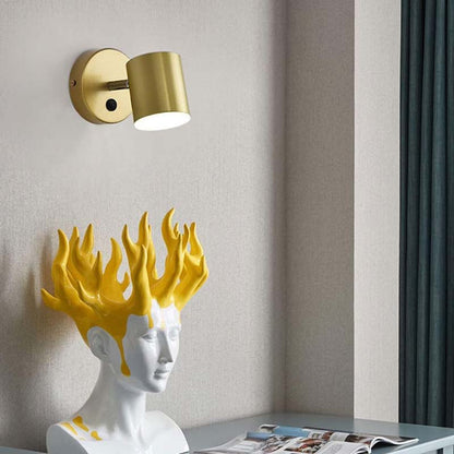 Decorative wall lamp with gold fixture on a neutral wall.