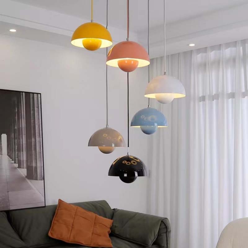 Colorful pendant lights hanging above a sofa in a modern living room.