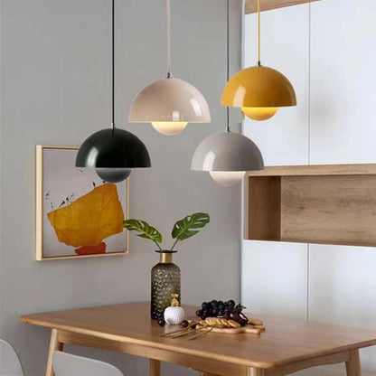 Dining area with pendant lights, a table, and decorative items.