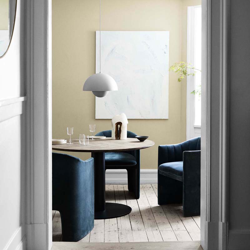 Minimalist Pendant Lamp Dome in a modern dining room with a round table and blue chairs in a well-lit space.
