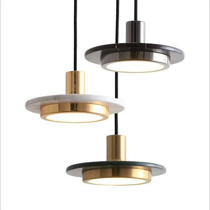 Three modern pendant lights with gold and black finishes on a white background