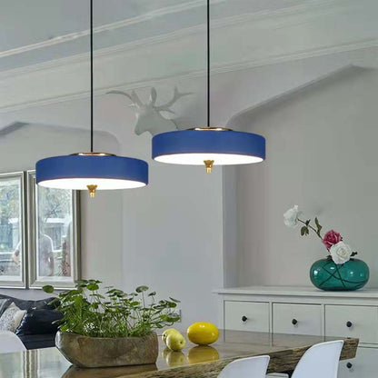 Modern blue pendant lights in a living room setting with decor elements.