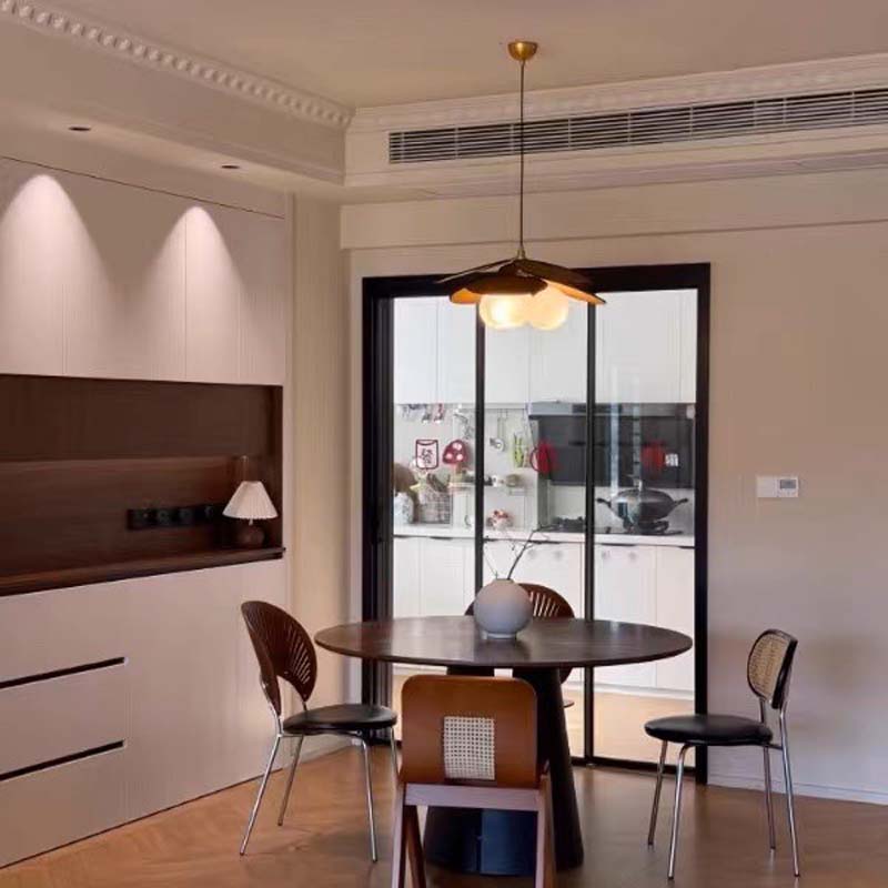 Modern pendant lamp over a round dining table