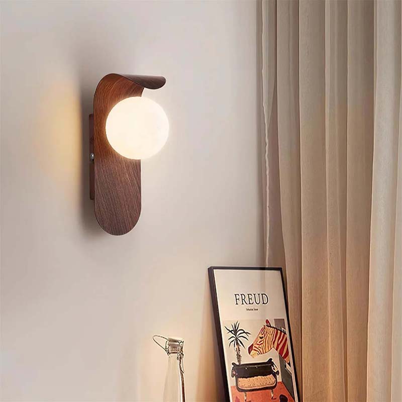 Wall lamp with a bulb on a neutral wall.