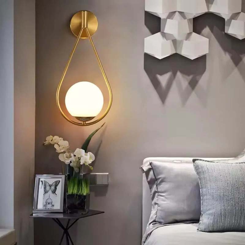 Modern wall lamp with a decorative wall art piece in a living room setting.
