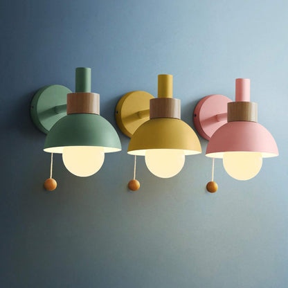 Three colorful wall lights on a blue wall
