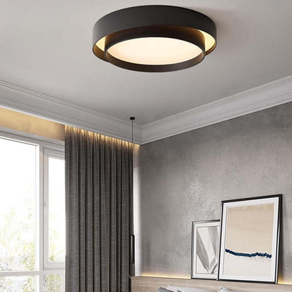 Modern ceiling light fixture in a room with gray walls and framed pictures.