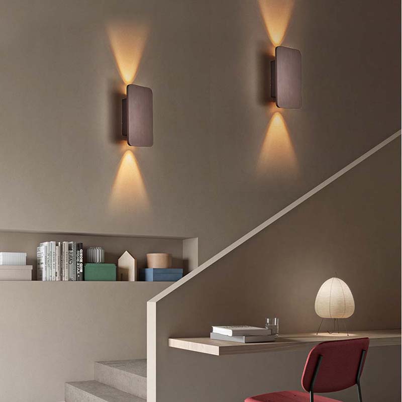 Modern wall lights on a staircase with a minimalistic interior design.