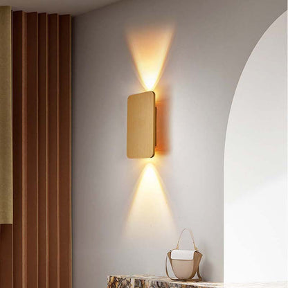 Modern wall-mounted light fixture on a gray wall with a curtain and mirror in the background.