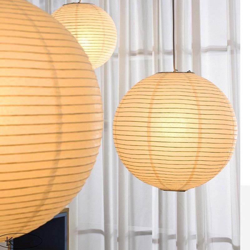 Paper lantern pendant lights glowing softly in a bright room.