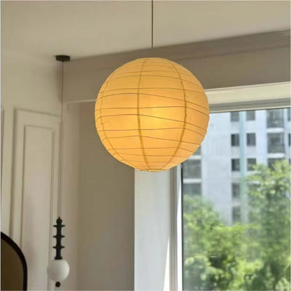 Paper pendant lamp by the window in a bright room.