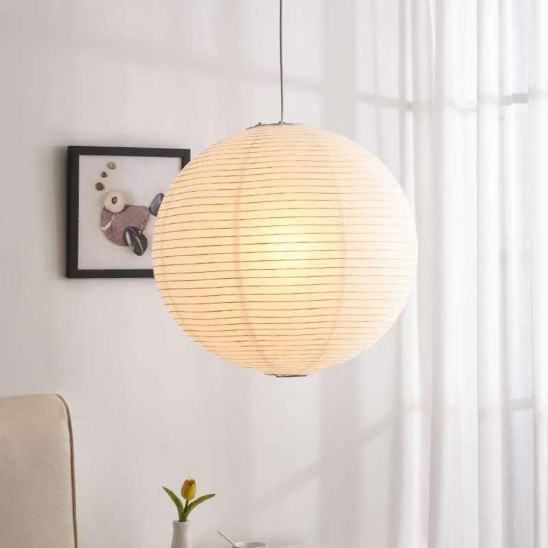 Paper pendant lamp glowing in a bright minimalist room