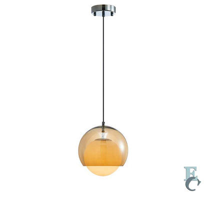 Pendant light with amber glass shade on a white background