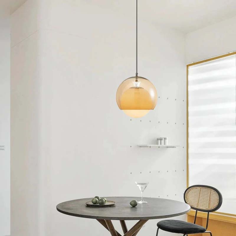 Pendant Globe Light in a modern dining room with a round table and chair.