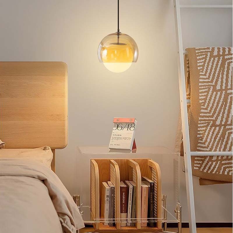 Pendant Globe Light in a bedroom with a wooden headboard and a nightstand with books