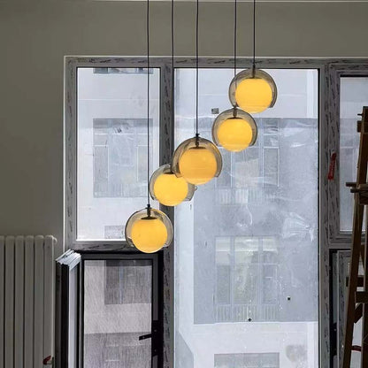 Modern pendant lights hanging in a room with large windows.
