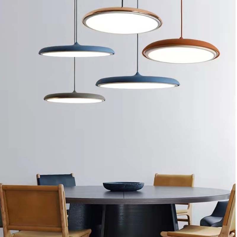 Modern Pendant Lamp Luna. Wini Macaron 4 Lunrlighting hanging over a dining table and chairs.