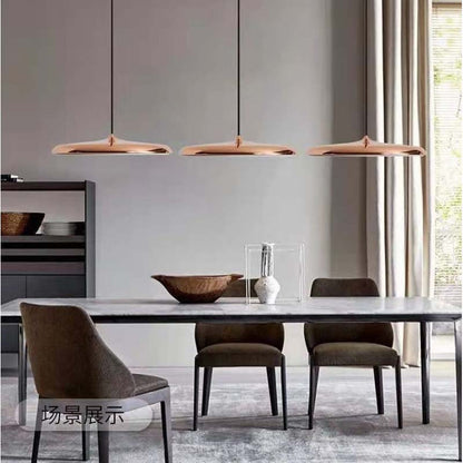 Pendant Lamp Luna. Wini Macaron 4 Lunrlighting in a modern dining room with a table and chairs.
