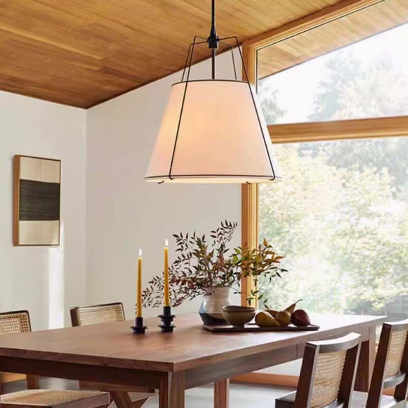 Dining room with a large pendant light, wooden table, and chairs.