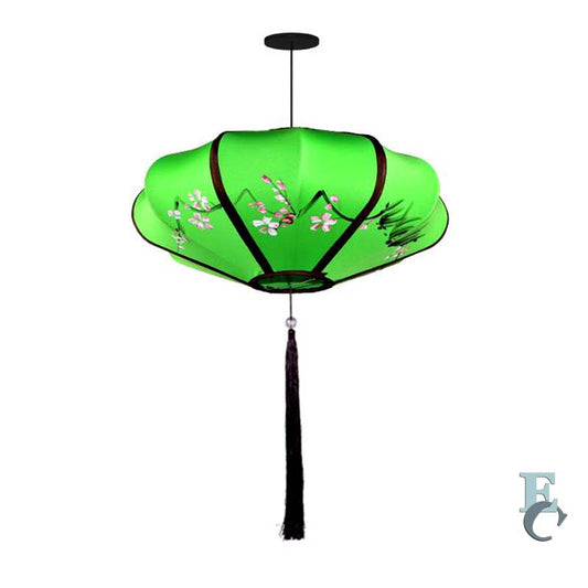 Green decorative lamp with floral patterns on a white background