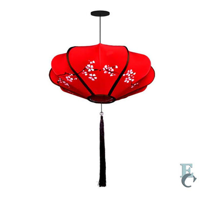 Red floral lantern with a black tassel on a white background