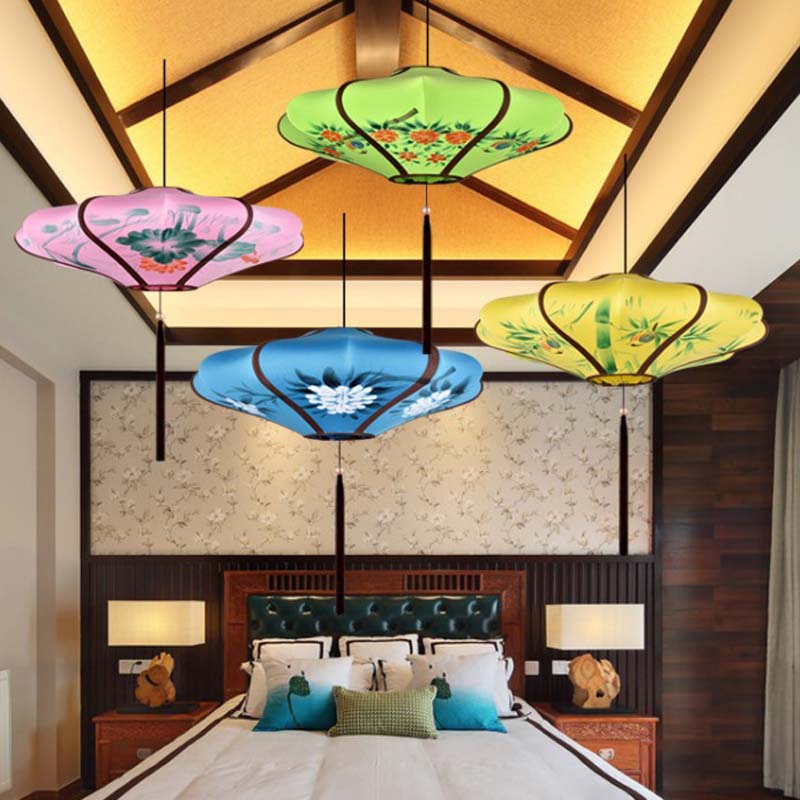 Colorful ceiling lamps hanging in a bedroom with wooden furniture and decorative pillows.
