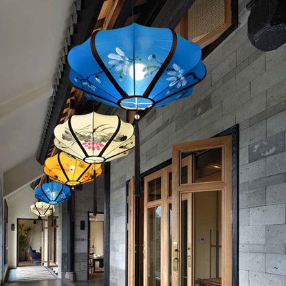 Colorful ceiling lamps hanging in a hallway with stone walls and wooden doors.