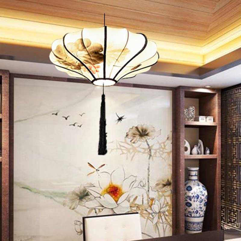 Ceiling light fixture in a room with floral wall art and a vase.
