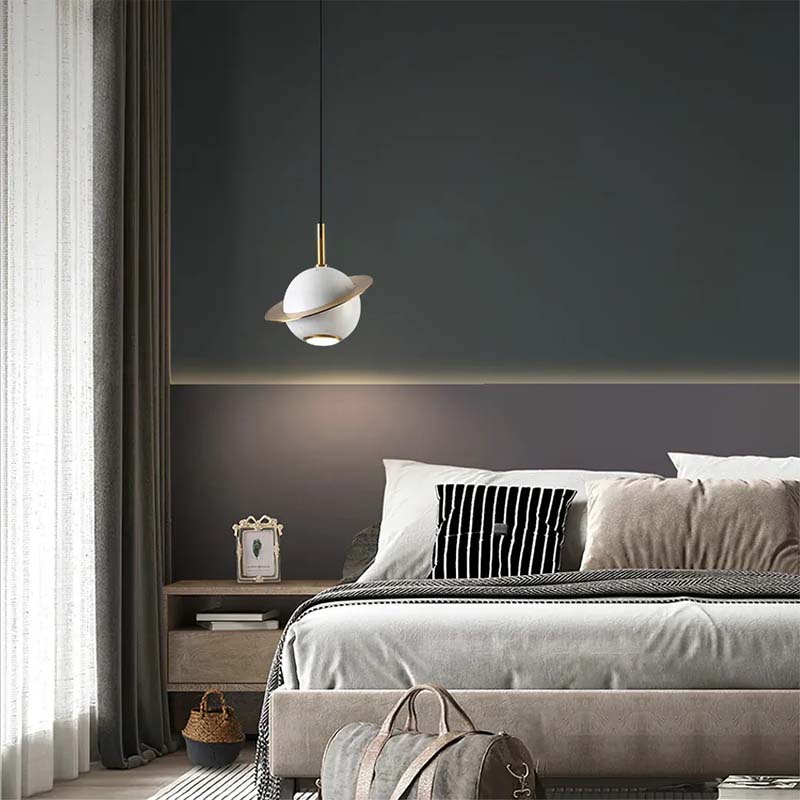 Modern bedroom with a pendant light fixture, bed, and nightstand.