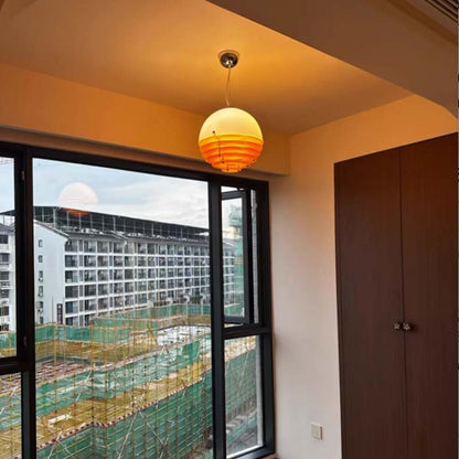Pendant lamp with soft light in a modern room by the window.