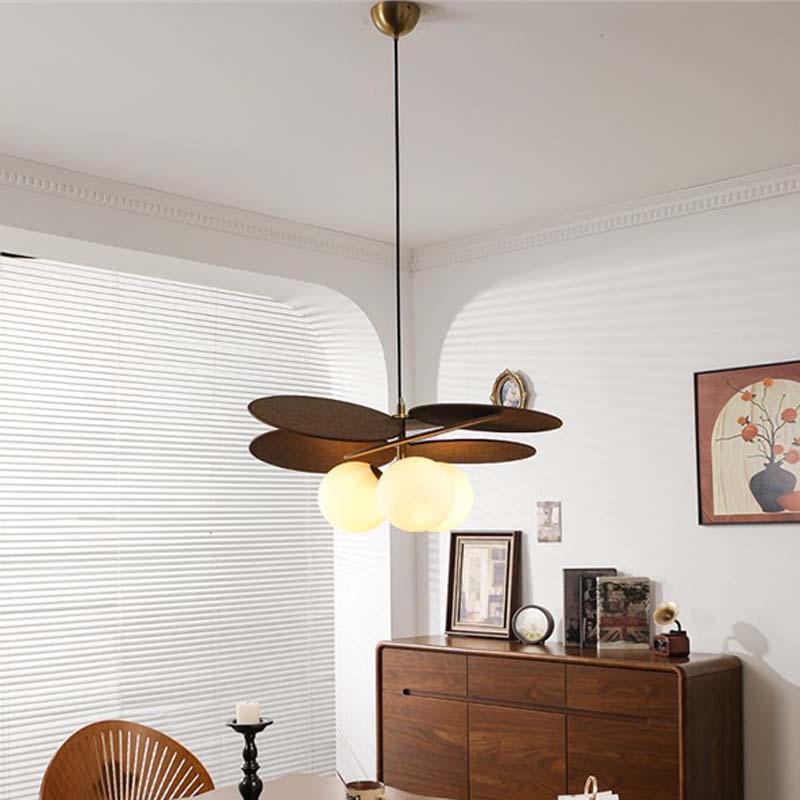 Pendant light with wooden petal shades above a table