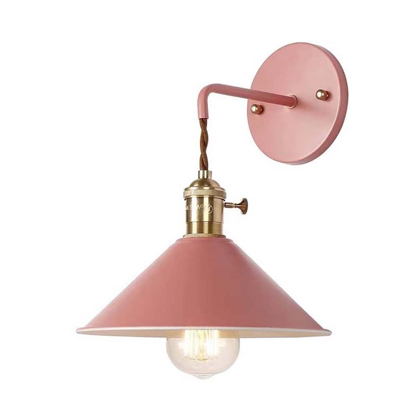Pink wall lamp with brass fitting on a white background