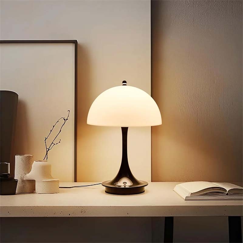 Table lamp on a desk with a soft glow in a room setting