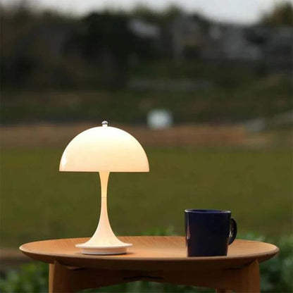 Table lamp on a wooden table with a blurred natural background