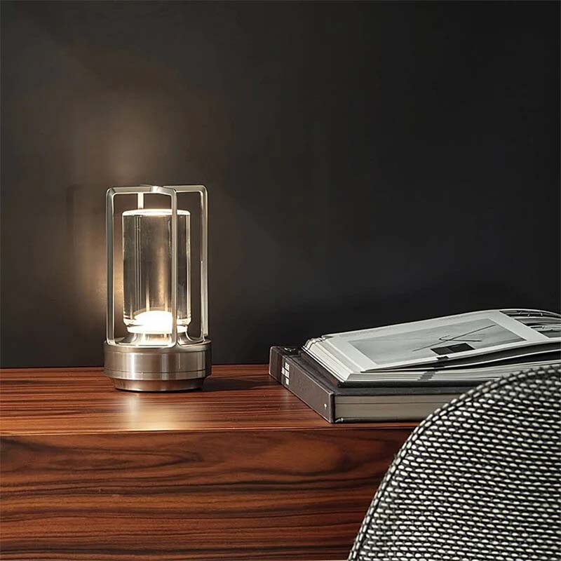 Modern glass table lamp on a wooden surface with a dark background