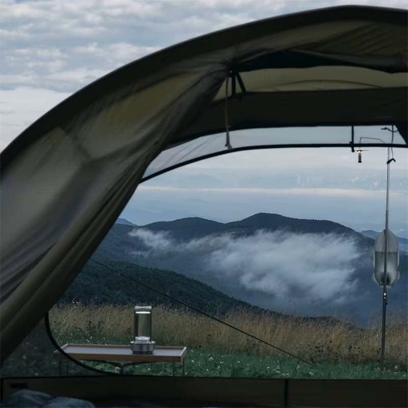 Portable Touch LED Lamp Crystal at a campsite with a tent overlooking the mist-shrouded mountains.