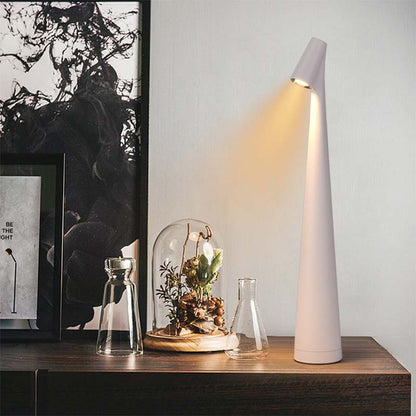 Modern table lamp on a wooden surface with decorative elements.