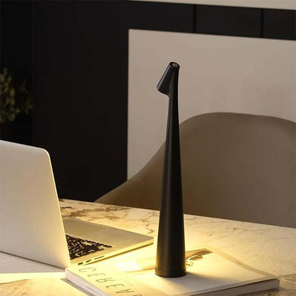 Black desk lamp on a marble surface with a laptop and notebook