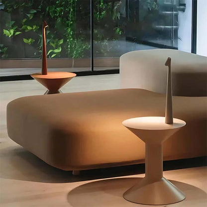 A modern living room with a beige sofa and side tables topped with table lamps.