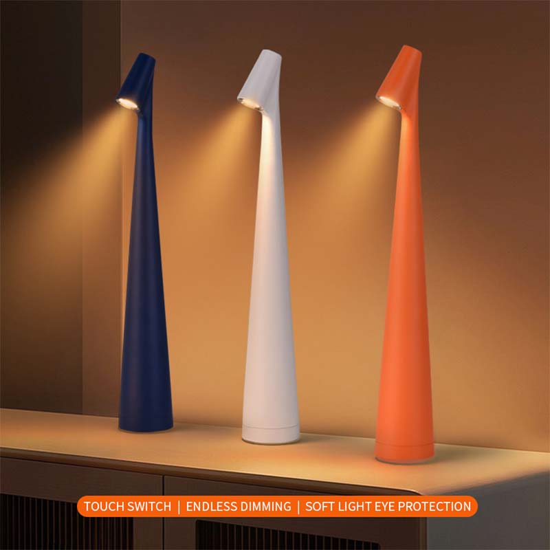 Three cone-shaped table lamps in blue, white and orange colors emit a warm light on a wooden surface.