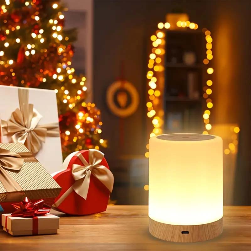 White night light on a wooden surface with Christmas decorations in the background