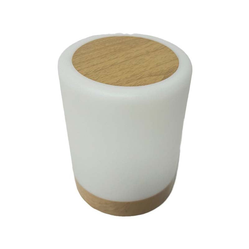 White cylindrical lamp with wooden top and bottom on a white background